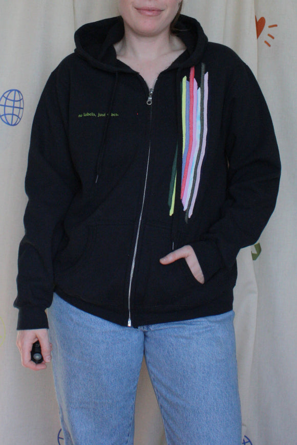 upcycled black zip up hoodie with colourful fabric stripes on the front, repurposed in canada