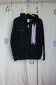 upcycled black zip up hoodie with colourful fabric stripes on the front, repurposed in canada