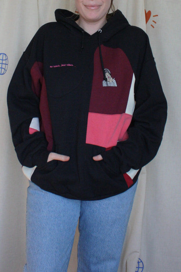 black upcycled hoodie, with patchwork design and pops of pink, cream and red, repurposed in canada