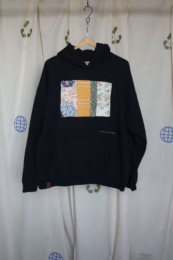 black upcycled hoodie with mustard and green quilt on the front, repurposed in canada