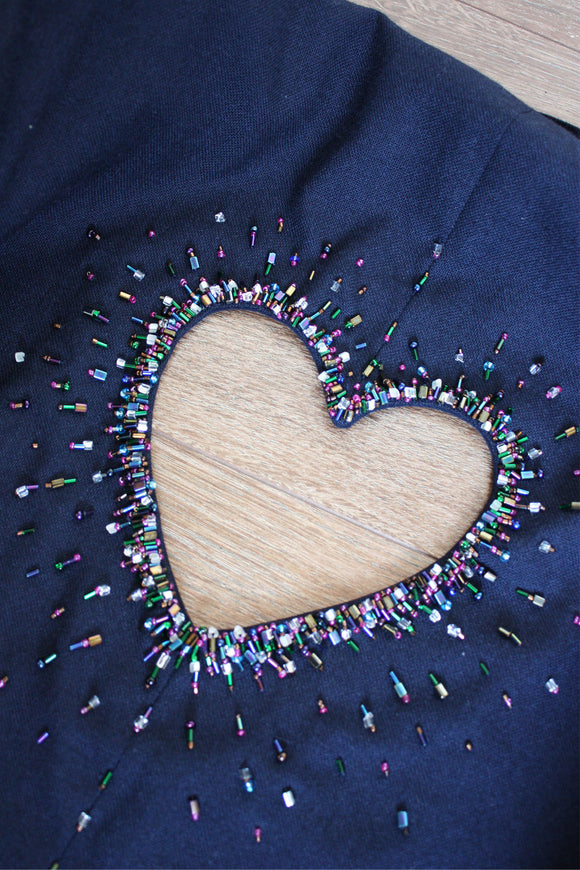 detail shot of upcycled navy blazer with heart cut out in the back with beading all around it, repurposed in canada