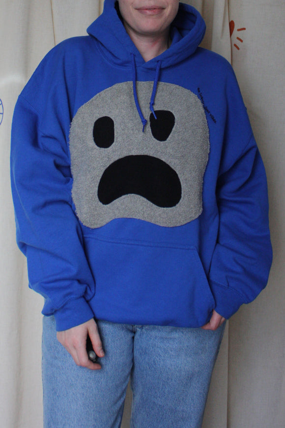 blue upcycled hoodie with fuzzy ghost face on front, repurposed in canada