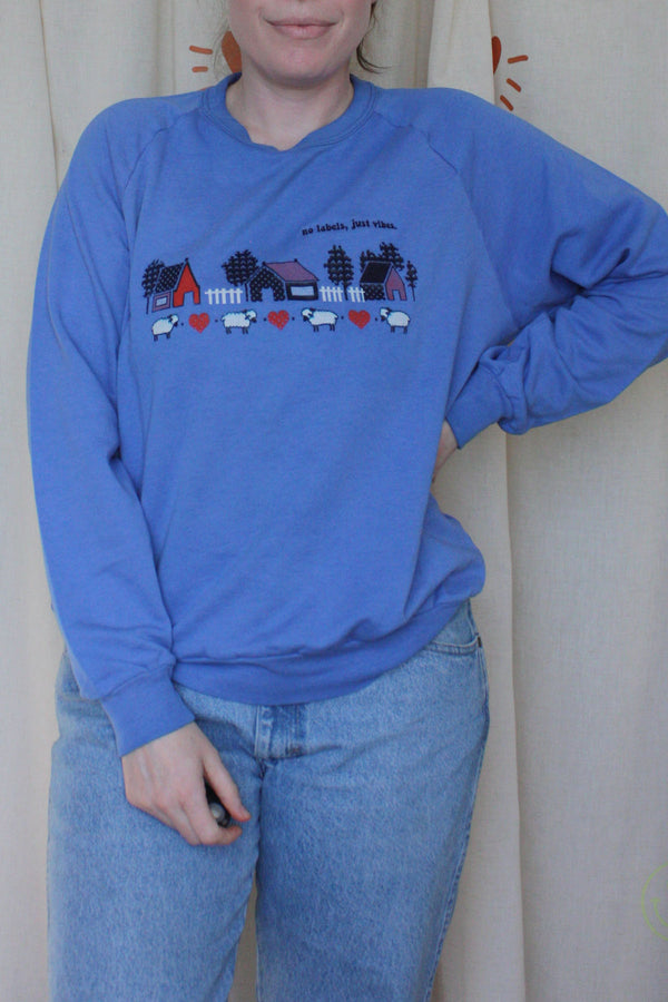 periwinkle upcycled grandma sweater with hearts, sheep and house motif on front, repurposed in canada