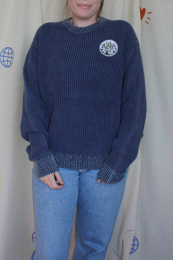 blue knit sweater with visible mending, upcycled in canada