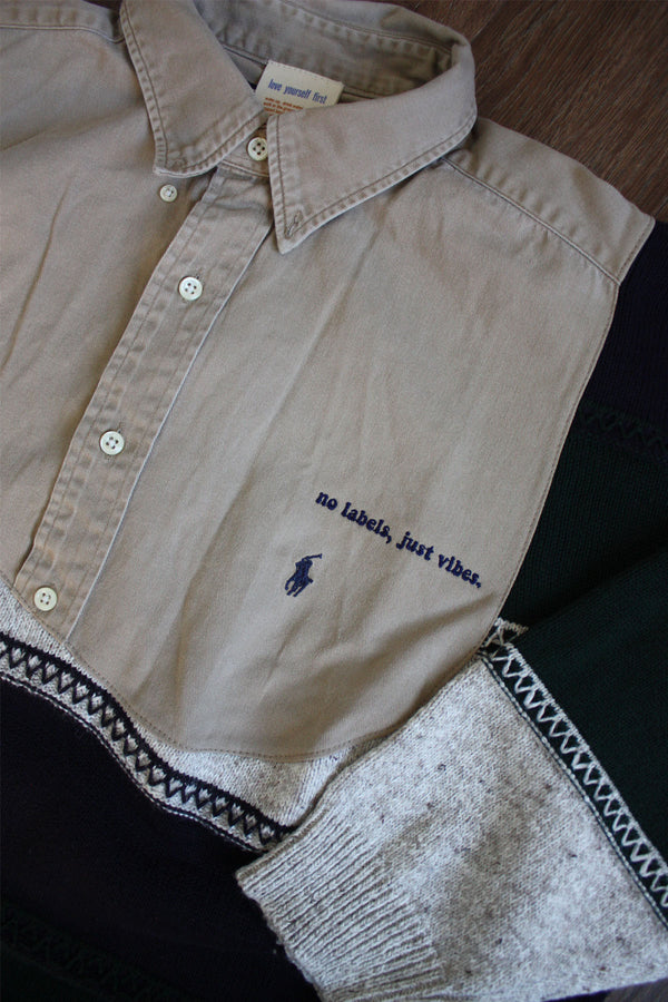 upcycled beige collared shirt with grandpa sweater, repurposed in canada detail shot of 'no labels, just vibes.' embroidery