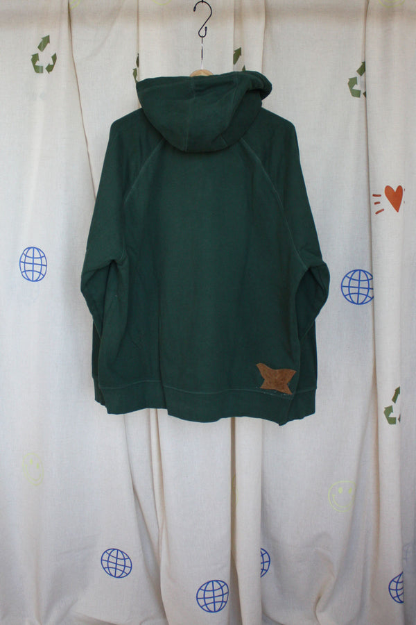 green upcycled hoodie with faux leather scraps sewn on front, with tan and camel colours and a suede butterfly on the front and back, repurposed in canada