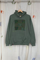 green upcycled hoodie with olive green patterned fabric and featuring a quilt block repurposed in canada