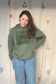 green upcycled hoodie with olive green patterned fabric and featuring a quilt block repurposed in canada