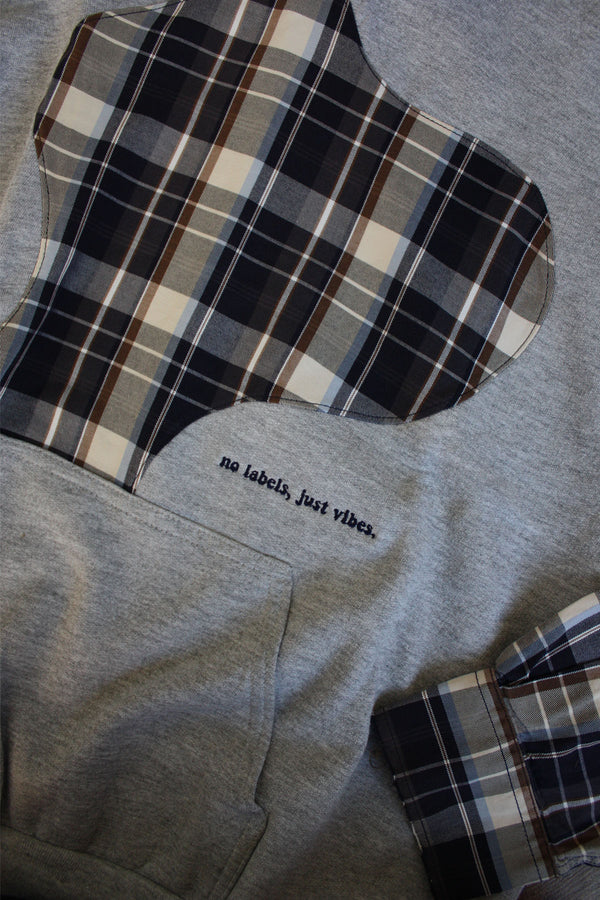 upcycled grey and plaid hoodie, with plaid sleeves, repurposed in canada, detail shot of 'no labels, just vibes.' embroidery