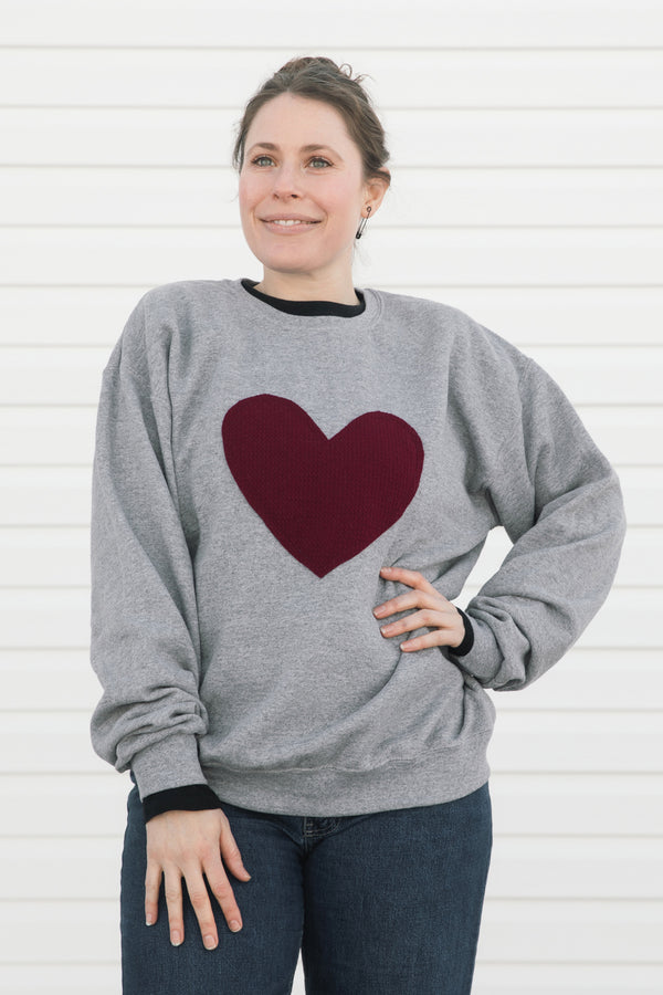 heather grey oversized sweater with cranberry heart applique, upcycled fabric, recycled fabric, handstitched in Ottawa