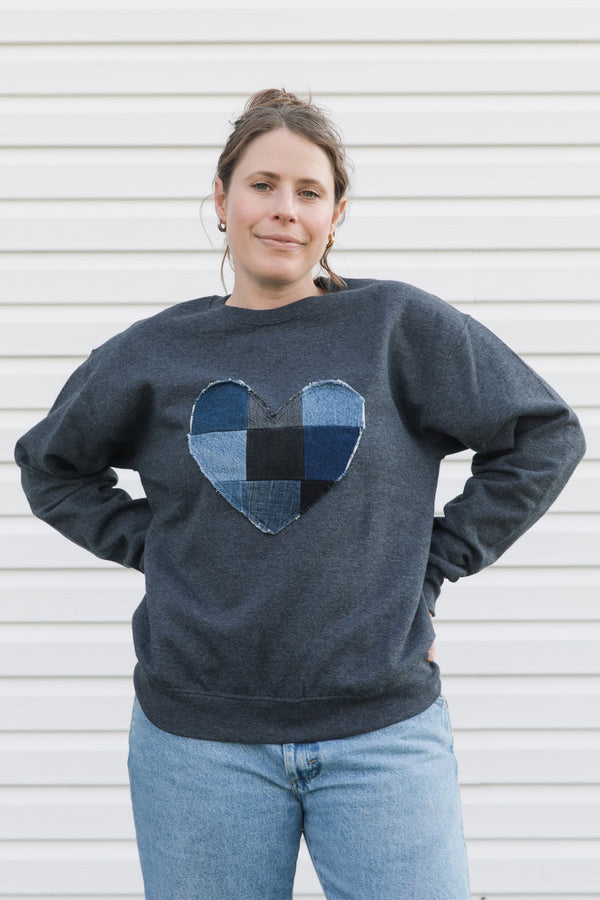 denim patchwork heart sewn on unisex sweater, charcoal grey with an oversized fit, made in canada