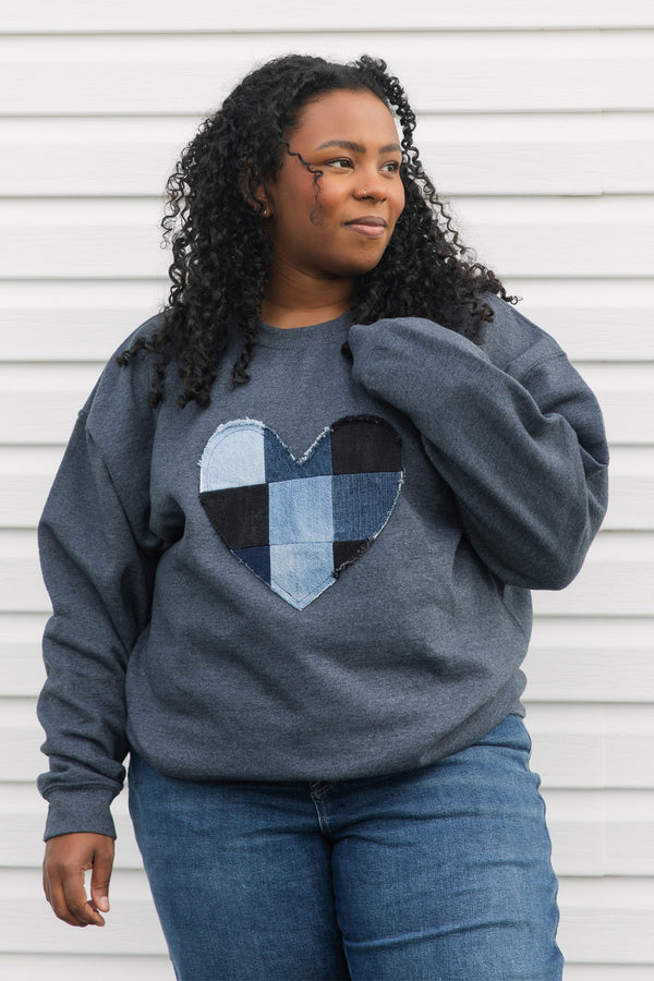 denim patchwork heart sewn on unisex sweater, charcoal grey with an oversized fit, made in canada