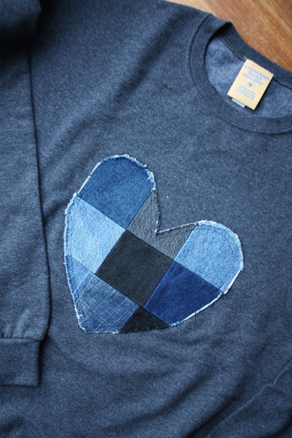 denim patchwork heart sewn on unisex sweater, charcoal grey with an oversized fit, made in canada