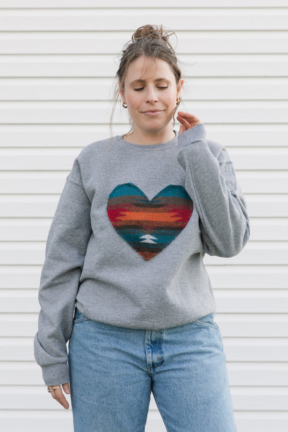 Indigenous multi-coloured pattern heart on light grey sweater, unisex and oversized, sewn in canada