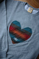 Indigenous multi-coloured pattern heart on light grey sweater, unisex and oversized, sewn in canada