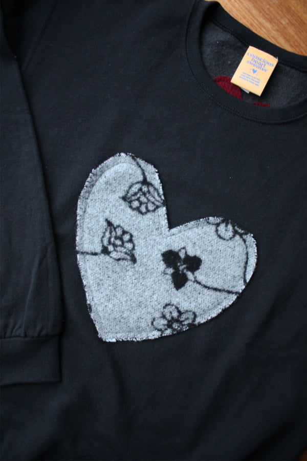 grey heart with floral design on black sweater, unisex and oversized fit, hand sewn in canada