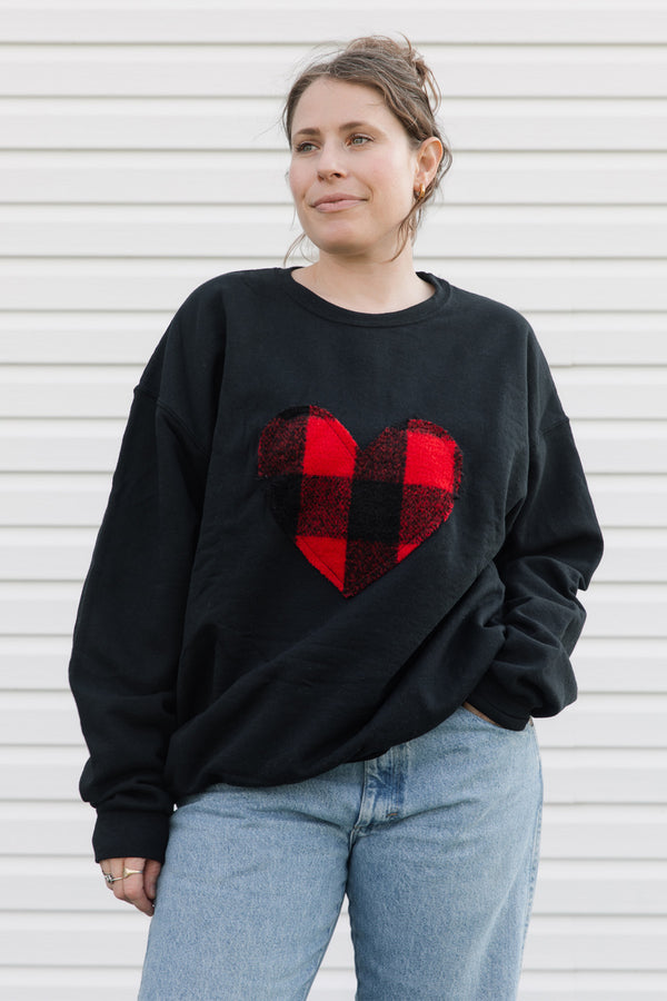 Red and black lumberjack plaid heart on black sweater, unisex and oversized, sewn in canada