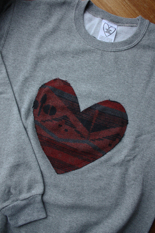 Indigenous printed heart sewn on heather grey sweater, unisex and oversized fit, sewn in canada