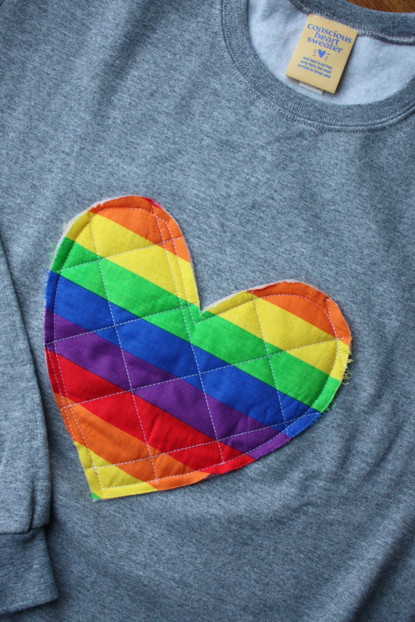 quilted rainbow heart sewn on heather grey sweater, unisex and oversized fit, sewn in canada