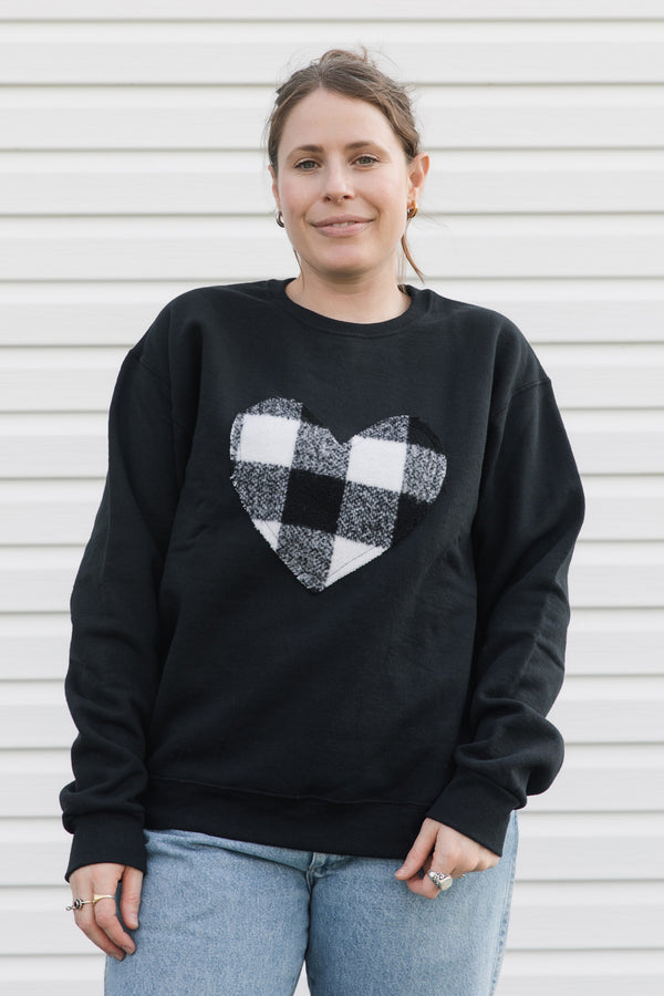 white plaid heart sewn on black sweater, unisex and oversized fit, sewn in canada