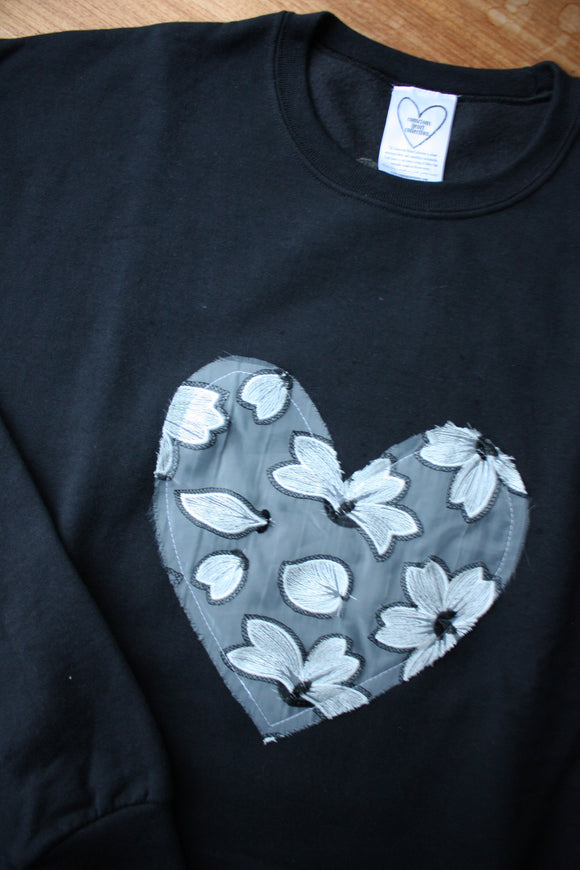 white floral lace heart sewn on black sweater, unisex and oversized fit, sewn in canada