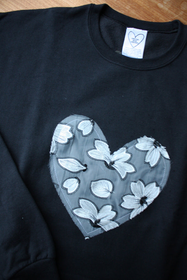 white floral lace heart sewn on black sweater, unisex and oversized fit, sewn in canada