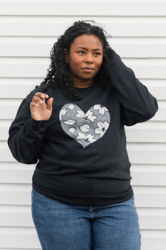 white floral lace heart sewn on black sweater, unisex and oversized fit, sewn in canada