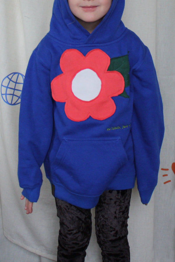 blue upcycled sweater worn by 5 year old, features coral flower with leaves on it, upcycled in canada