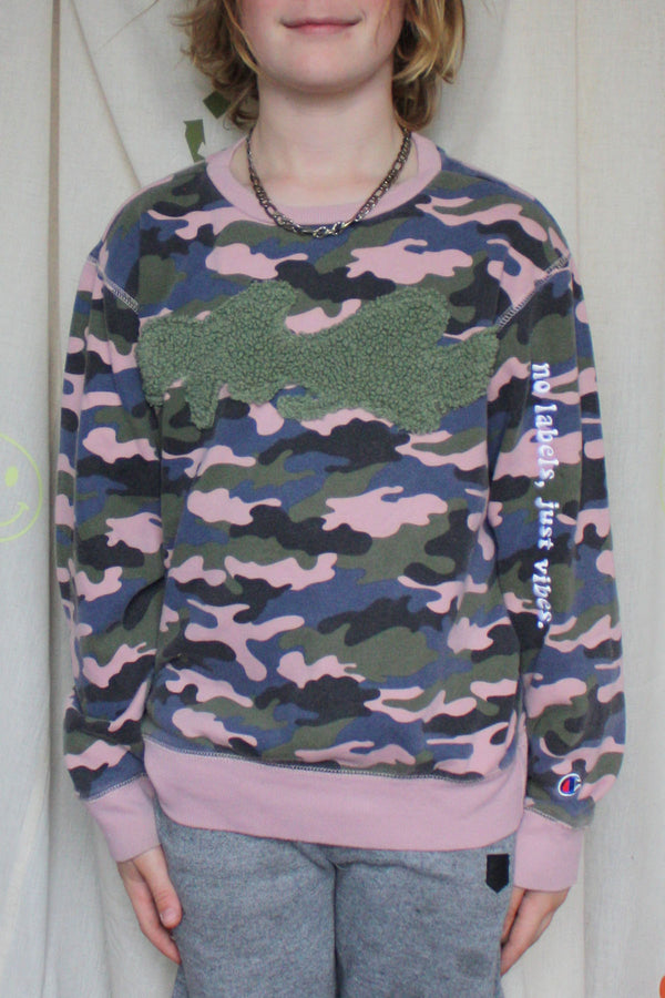 green, black and peach camo sweater worn by 9 year old, fuzzy green fabric on the front to mimic camo, upcycled in canada