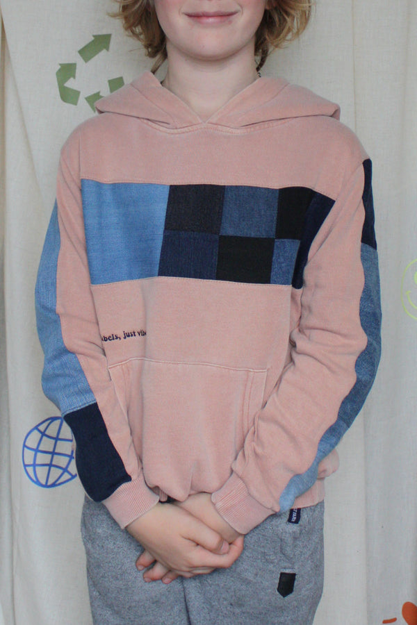 blush pink upcycled hoodie worn by 9 year old with denim details on front and sleeve, repurposed in canada