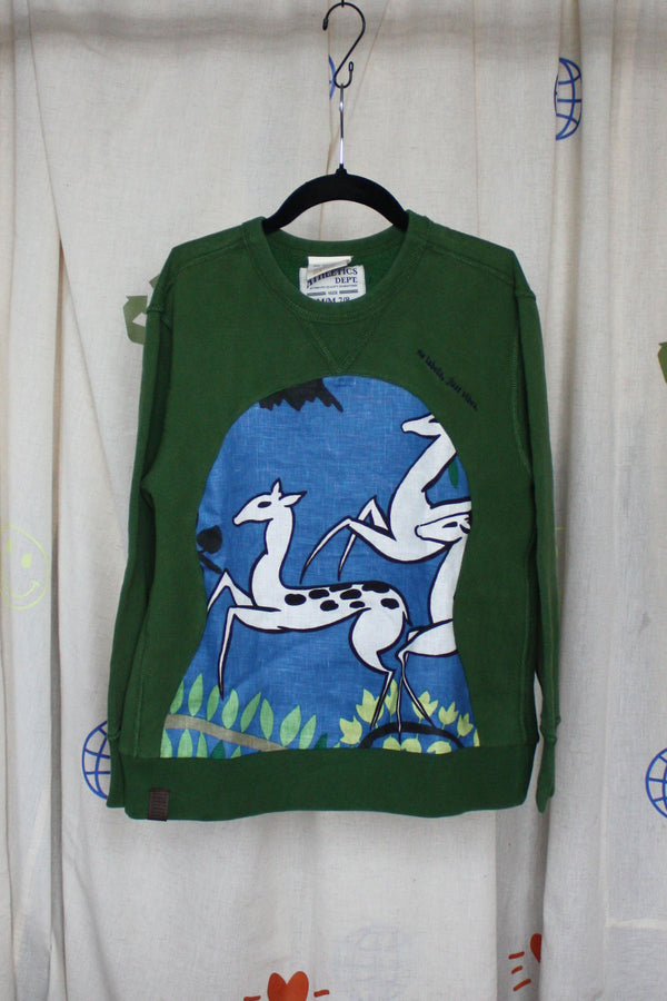 green sweater worn by 9 year old, features blue and green antelope print, repurposed in canada