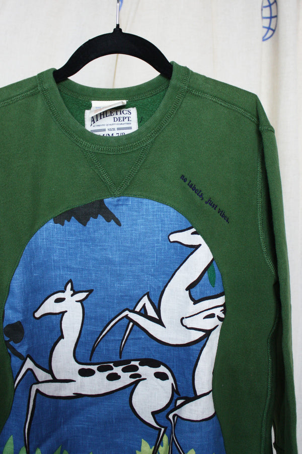 green sweater worn by 9 year old, features blue and green antelope print, repurposed in canada