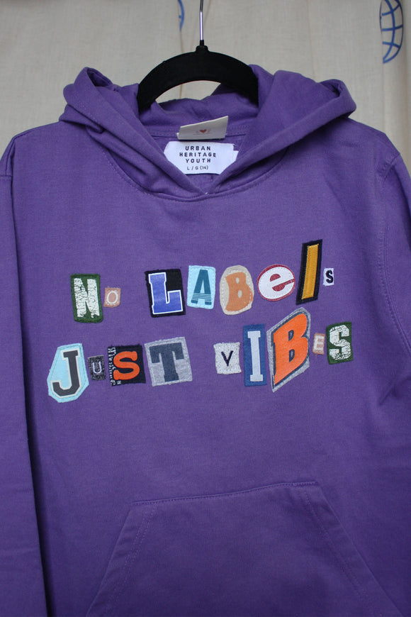 purple upcycled hoodie, with random letters spelling no labels just vibes repurposed in canada