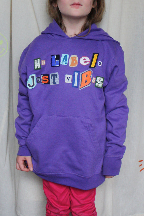 purple upcycled hoodie, with random letters spelling no labels just vibes repurposed in canada