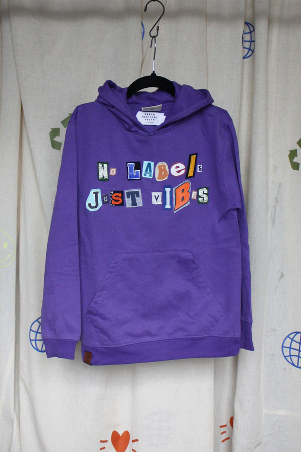 purple upcycled hoodie, with random letters spelling no labels just vibes repurposed in canada