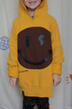 yellow upcycled hoodie worn by 6 year old, brown smiley face repurposed in canada