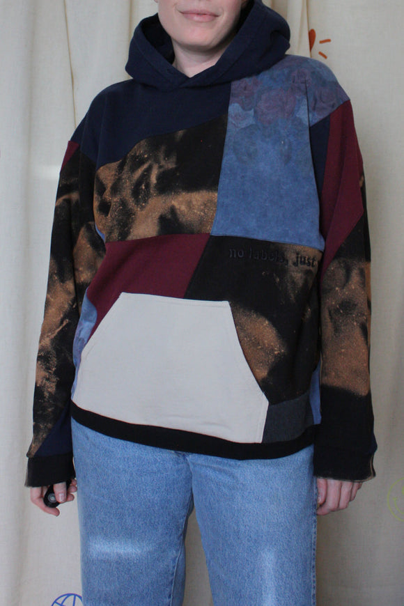 upcycled bleached sweater with navy hood and pops of cranberry, repurposed in canada