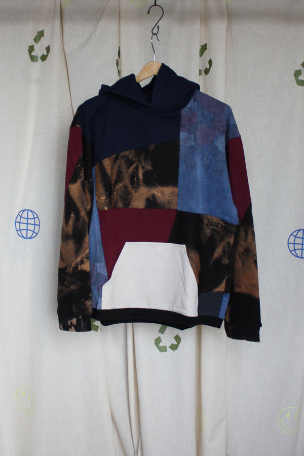 upcycled bleached sweater with navy hood and pops of cranberry, repurposed in canada