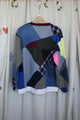 patchwork sweater made from scrap fabric, repurposed secondhand clothing, circular fashion