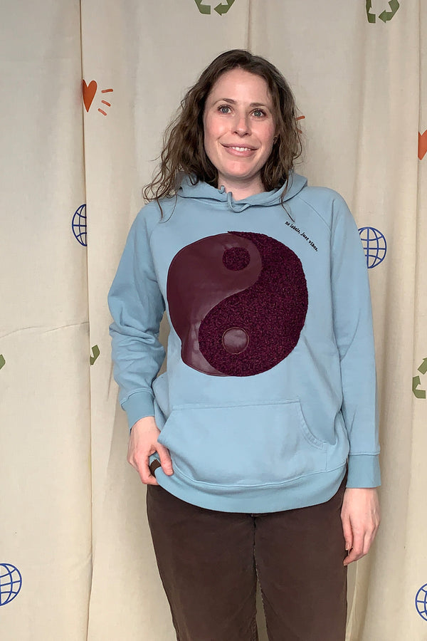 aqua upcycled hoodie with plum coloured yin yang symbol repurposed in canada