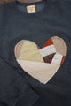 one of a kind quilted heart stitched on a charcoal sweater, unisex and oversized fit, hand cut and sewn in canada