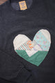 one of a kind quilted heart stitched on a charcoal sweater, unisex and oversized fit, hand cut and sewn in canada