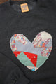 one of a kind quilted heart stitched on a charcoal sweater, unisex and oversized fit, hand cut and sewn in canada