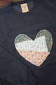 one of a kind quilted heart stitched on a charcoal sweater, unisex and oversized fit, hand cut and sewn in canada