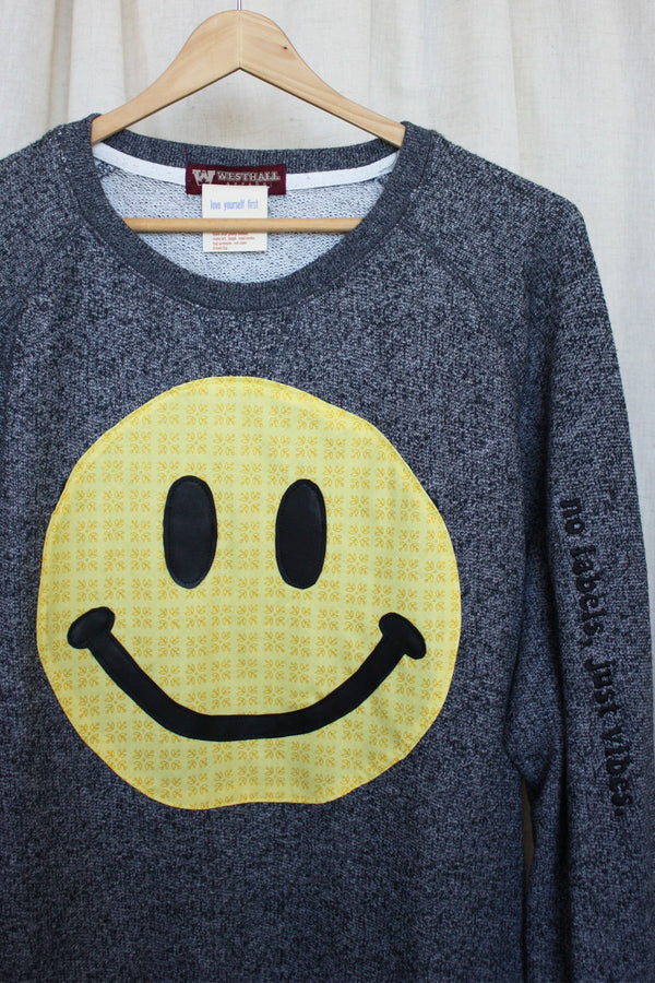 yellow smiley face on dark grey sweater, repurposed secondhand clothing, upcycled fashion