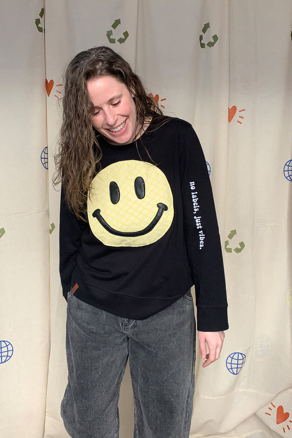 yellow smiley face on dark grey sweater, repurposed secondhand clothing, upcycled fashion