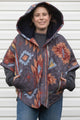 brown, blue and grey quilt upcycled into a poncho featuring fashionable hood, oversized fit and convenient pockets. made in canada