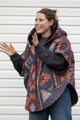 brown, blue and grey quilt upcycled into a poncho featuring fashionable hood, oversized fit and convenient pockets. made in canada