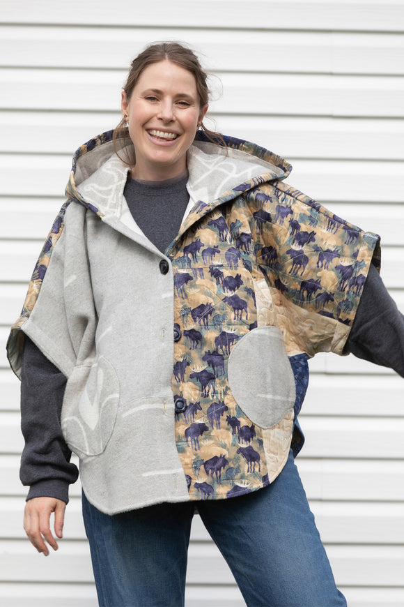 oversized poncho designer upcycled from blue and grey quilt and blanket, featuring a big hood, pockets and oversized style. Upcycled and made in canada