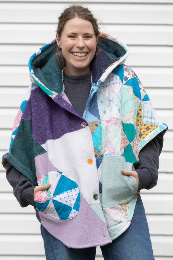 pastel coloured Clare Poncho, featuring a huge hood, pockets and oversized fit. upcycled and made in Canada